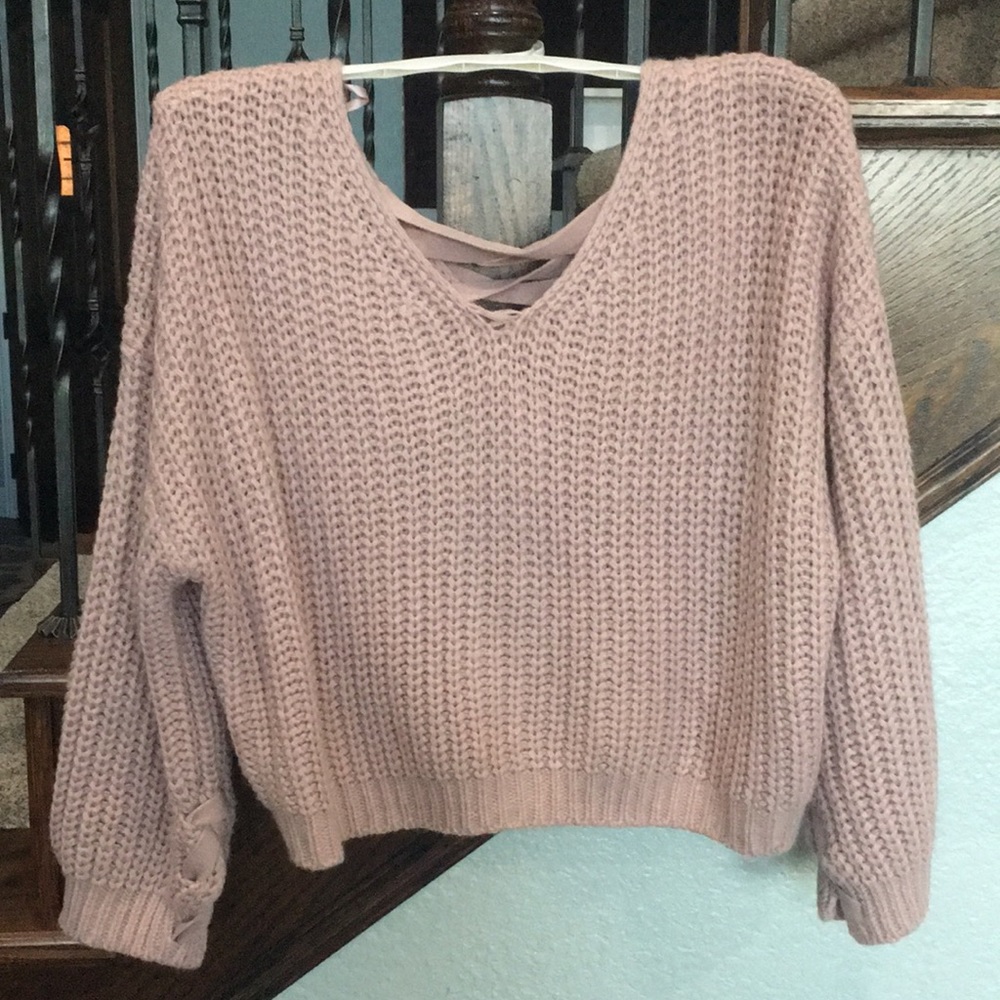 Knitted blush colored sweater.